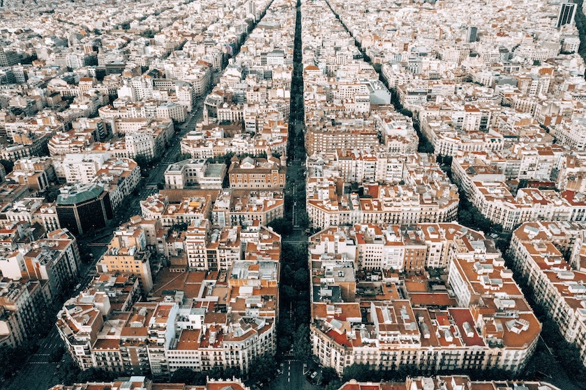 Aerial view of a city with grid-like streets and rows of red-tiled roofs, separated by a wide tree-lined avenue—perfect inspiration for your Spain Itinerary 10 Days adventure.