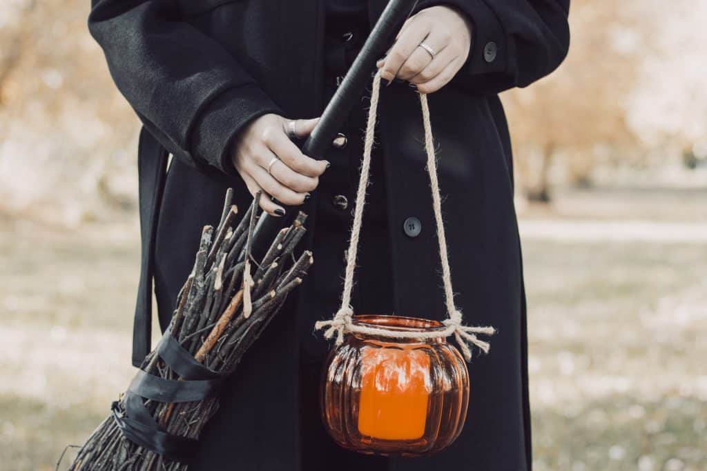 Witch holding broom and Candle