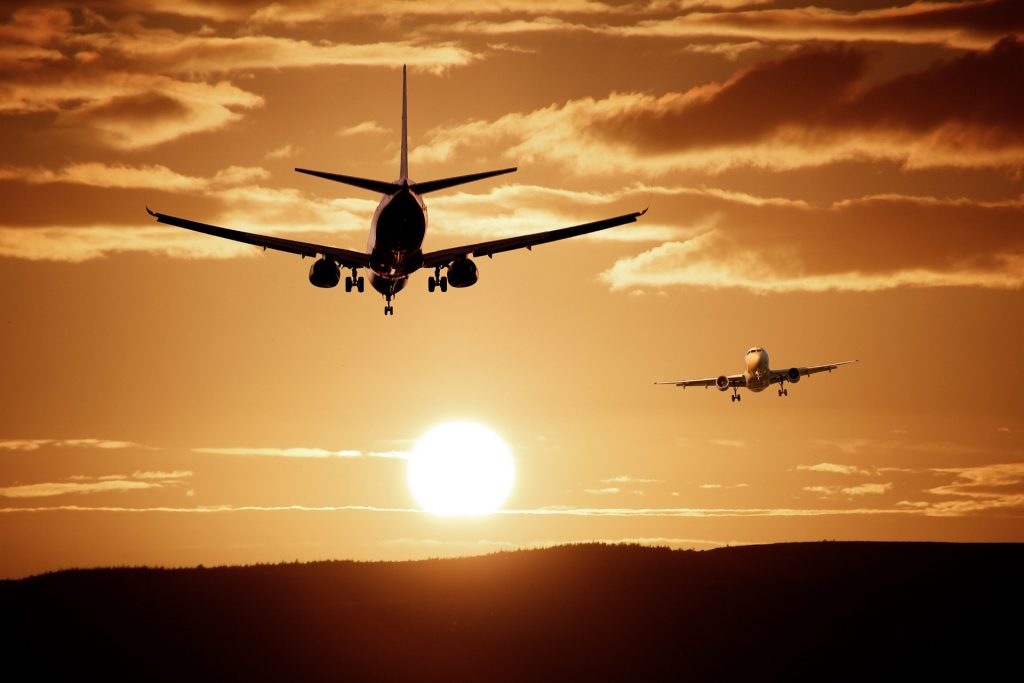 Airplane leaving over a sunset