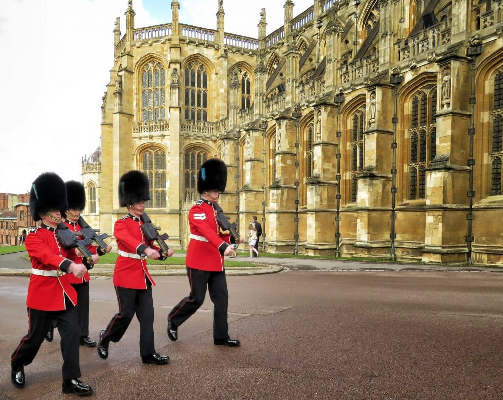 Red Uniformed guardsmen march before the Queen of England arrives to Sunday Easter Service at Windsor Palace in London, United Kingdom