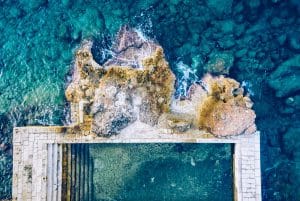 Top-down view rocky beach and clear blue water background.Beach located on the Adriatic sea coastline, Dubrovnik