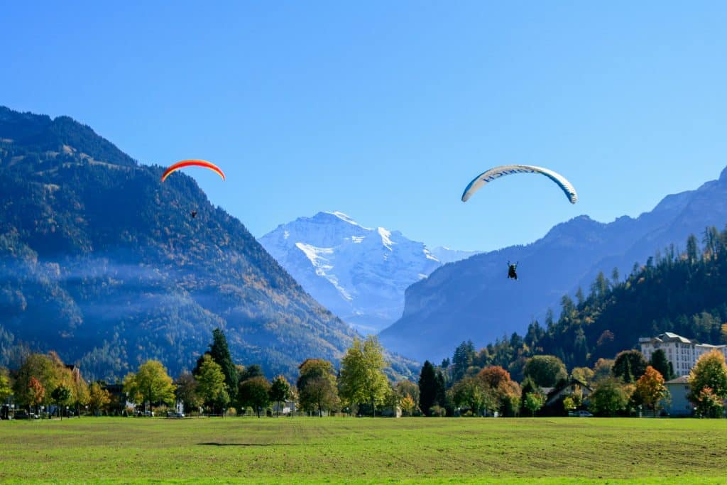 A peaceful view on 2 paragliders in Interlacken, Switzerland